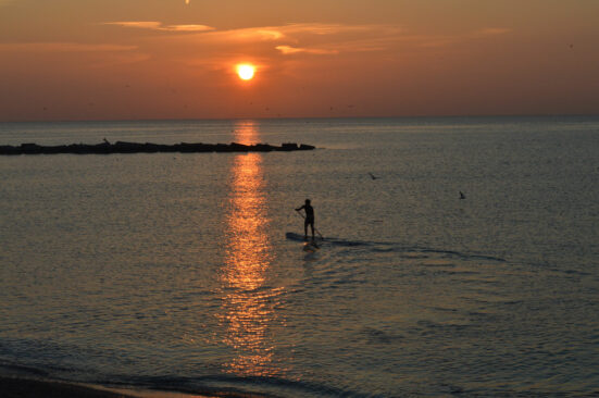 Paddle surfer at sunrise in Barcelona